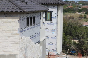 White limestone applied to a custom home in austin Texas with white mortar